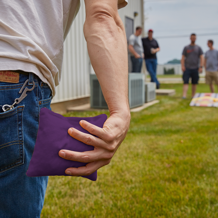 Purple ACA tossing cornhole bag