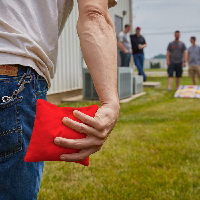 Red ACA tossing cornhole bag